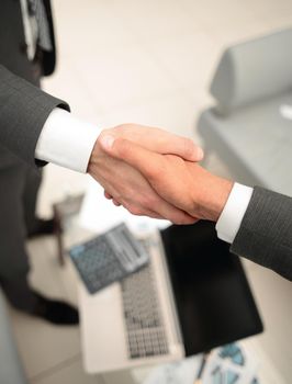 close up.business handshake over blurry background.business concept