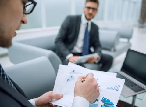 close up.businessman checks the financial document.business background