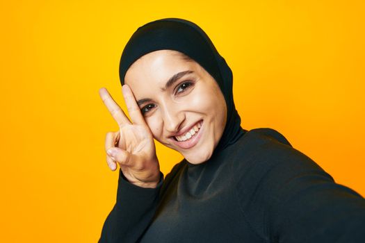 cheerful woman happiness fashion clothing hand gesture yellow background. High quality photo