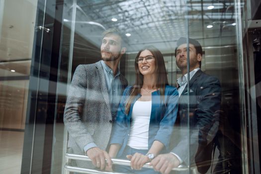 Business team group going on elevator.business concept