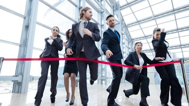 Businesspeople crossing the finish line rat race business people competition concept