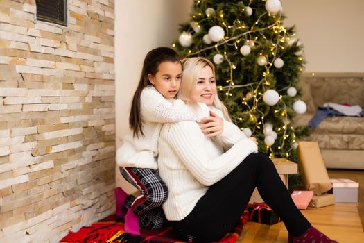 Christmas, happy family mother with daughter with gifts on Xmas Eve