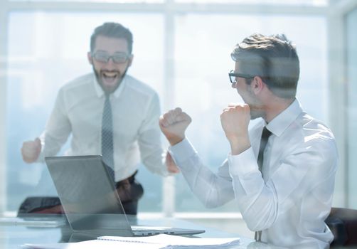 happy employees, happy about the good news online.the concept of victory