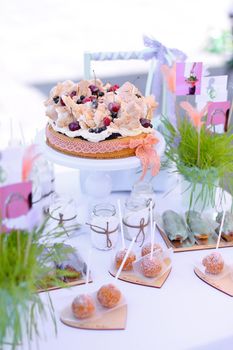 Sweet cakes on white table for birthday party. Concept of sweets and tasty food.