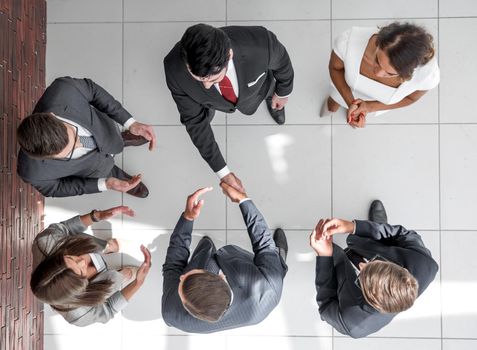 top view.business partners shaking hands.business concept