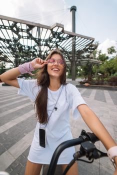 Young beautiful woman and an electric scooter, modern girl, new generation, electric transport, ecological transport