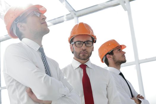 close up.background image of a group of business people in protective helmets