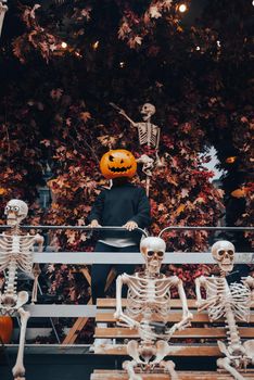 Girl with a pumpkin head posing at the street. Halloween Concept