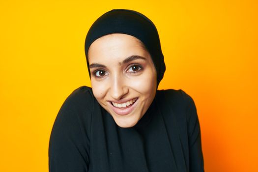 arab woman happiness fashion clothing hand gesture yellow background. High quality photo