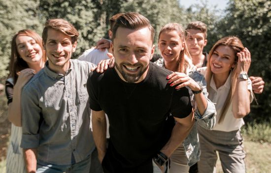 leader and the business team have fun in their free time. team building outdoors