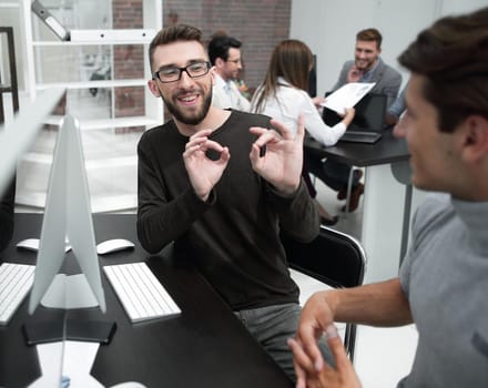 business team is discussing something sitting at the Desk.business concept