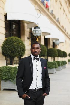 Afro american man wearing suit and standing outside. Concept of black businessman.