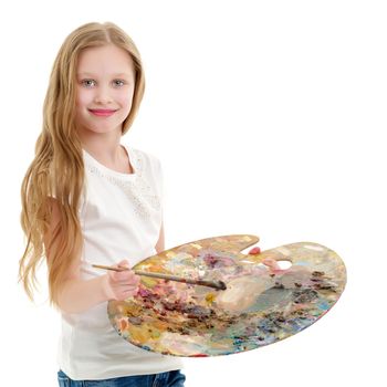 Cute little girl with a palette and a brush. The concept of children's creativity, learning to draw.