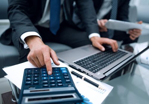 close up.businessman using a calculator for calculating financial profit.business concept