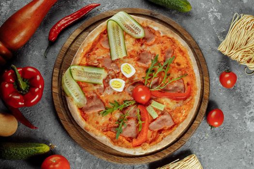 Children's pizza in the shape of a cat's face on a white plate, on a white background, top view. Children's menu.