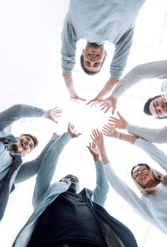 smiling business team standing in a circle. the concept of unity