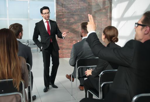 man standing in front talking to a group of business people