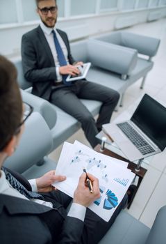 close up.the businessman checks the financial report.business concept