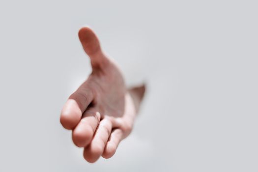 close up.a man's hand breaking through the paper wall .photo with copy space