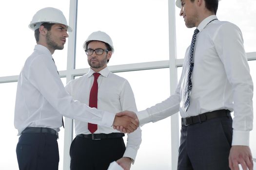 Two architects shaking hands after a meeting in office.concept of cooperation