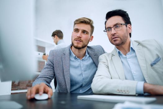 two businessmen use a computer to get new information.people and technology