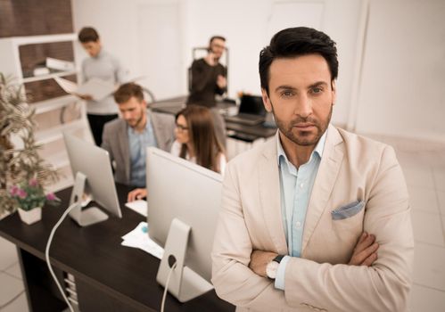 confident businessman in the background of his office.business people