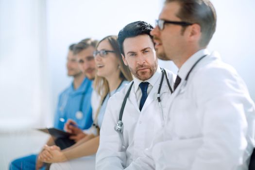 profession, medical education, health care, people and medicine concept - group of happy doctors on seminar in lecture hall at hospital