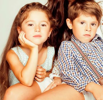 little cute boy and girl hugging playing on white background, happy family smiling close up