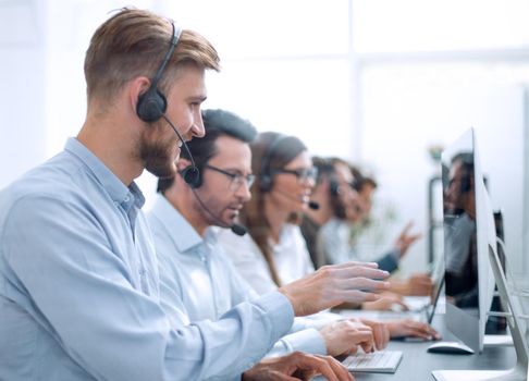 handsome man with a headset working in a call center.people and communication
