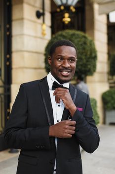 Afro american man wearing suit and standing outside. Concept of black businessman.