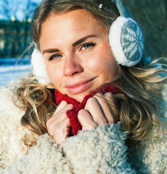 young pretty teenage hipster girl outdoor in winter snow park having fun drinking coffee, warming up happy smiling, lifestyle people concept close up