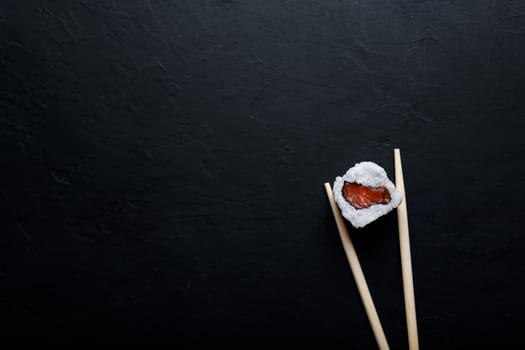 Sushi with tuna salmon rice and chopsticks on an isolated background.