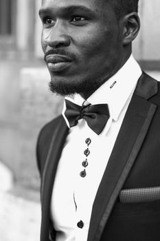 Black and white bw portrait of Afro american handsome man wearing suit and smiling. Concept of black businessman. in Paris