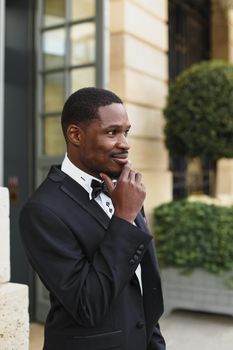 Afro american man wearing suit and standing outside. Concept of black businessman.