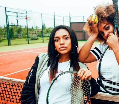 young pretty girlfriends hanging on tennis court, fashion stylish dressed swag, best friends happy smiling together lifestyle close up