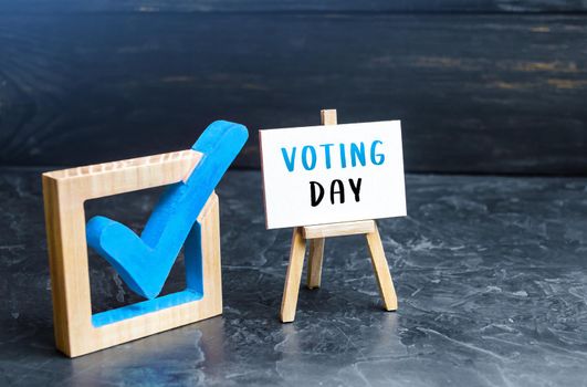 Blue tick and easel Voting Day. Parliament or president elections. Democratic processes, fair competition, legitimization of power. Vote for political forces and candidates, representatives in power.