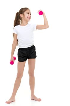 A cute little girl doing exercises with dumbbells. The concept of strength, health and sport. Isolated on white background.