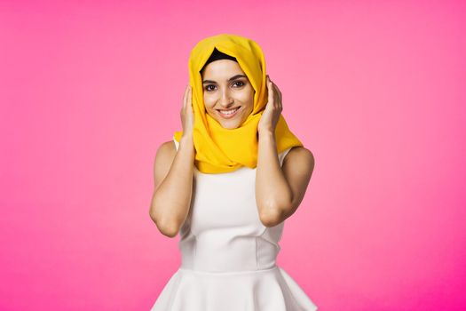 muslim woman in hijab posing fashion ethnicity pink background. High quality photo