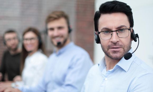 technical support specialist on the background of colleagues.business concept
