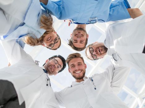 Young doctors as team stack hands together for motivation
