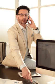 businessman uses his smartphone to discuss financial documents.business concept