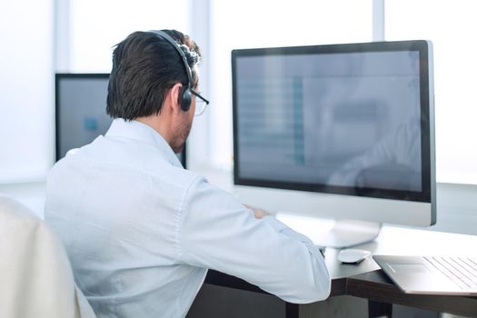 close up.businessman looking at the monitor of a modern computer.people and technology