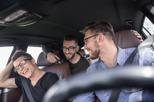 friendship, travel, vacation, summer and people concept - group of smiling friends traveling by car