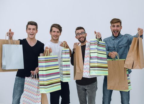 group of happy young friends with shopping bags.
