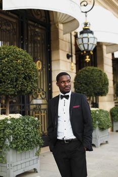 Afro american happy good looking man wearing suit and smiling outdoors. Concept of black businessman.