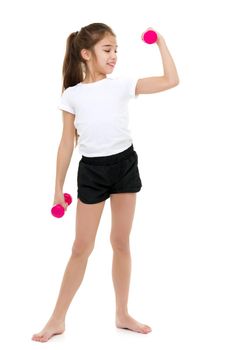 A cute little girl doing exercises with dumbbells. The concept of strength, health and sport. Isolated on white background.