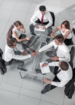 top view of multi ethnic startup business people group on brainstorming meeting in modern bright office interior