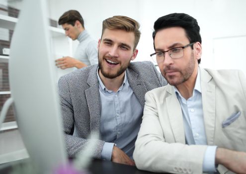 two businessmen use a computer to get new information.people and technology