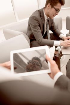 close up.businessman with a digital tablet in a modern office.people and technology