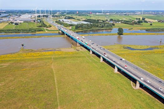 Aerial from the highway A27 near Nieuwegein at the Lek bridge in a flooded landscape in the Netherlands 